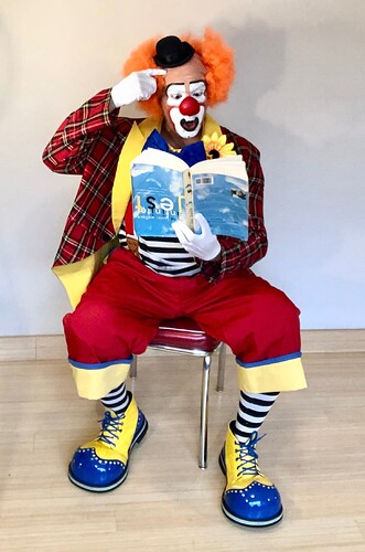 Auguste_clown_reading_a_book_upside-down